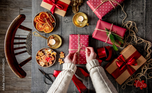 Female wrapping a cookies as a gifts on a table