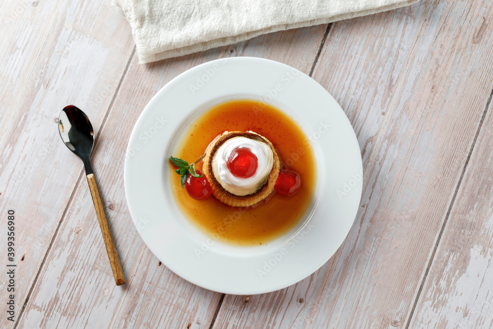 Egg flan with cream, cherries and mint Egg flan with cream, cherries and mint