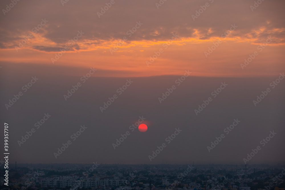 Beautiful sunset red sun over city.