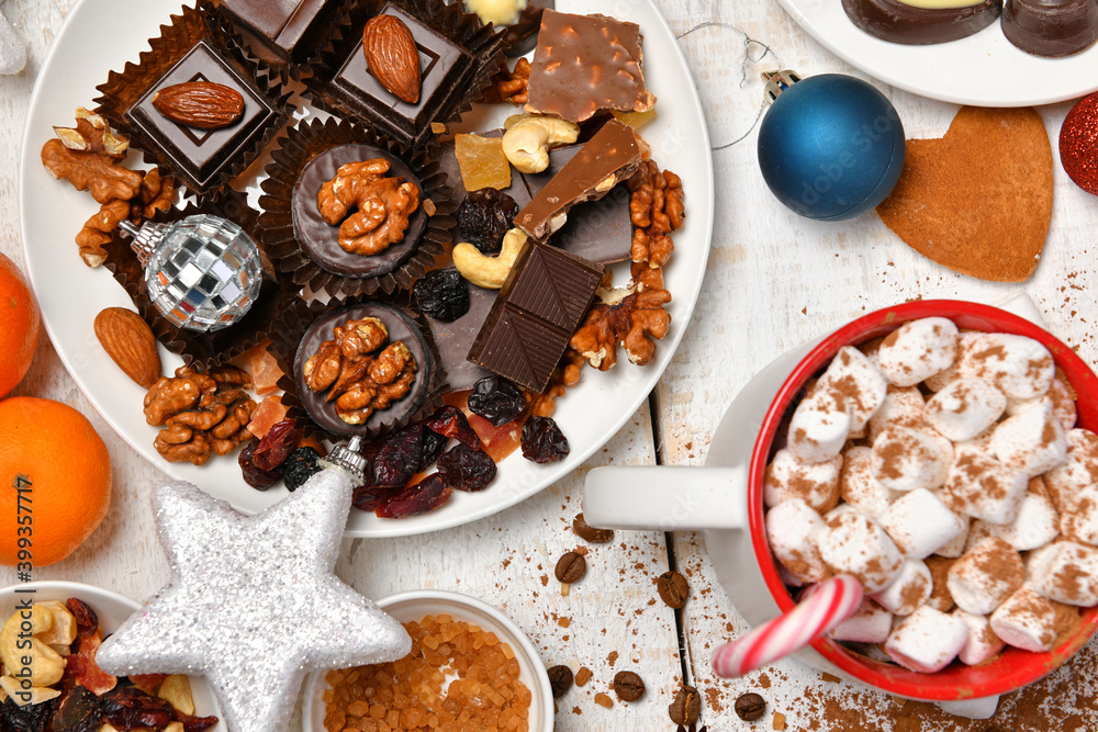 sweet food top view background for merry christmas or new year holiday decoration - chocolate candies, tangerines, cookies, marshmallow and cocoa latte on white wood sweet food top view background for merry christmas or new year holiday decoration - chocolate candies, tangerines, cookies, marshmallow and cocoa latte on white wood