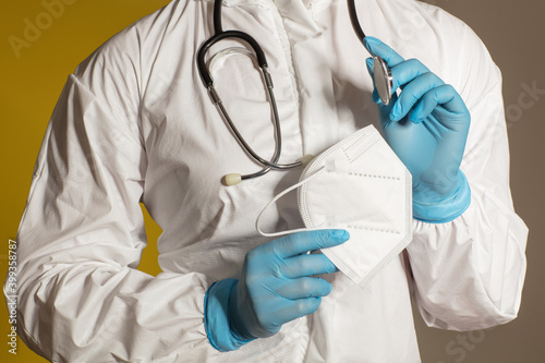 Doctor wearing a white overall, a stethoscope and nitrile gloves