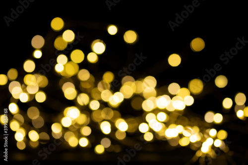 Abstract yellow lights Defocused on a dark background. Christmas background.