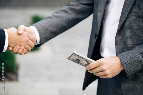Handshake - business people shaking hands. Two unrecognized business partners shaking hands. Colleagues just made good deal. Business relationship. Successfully made deal.
