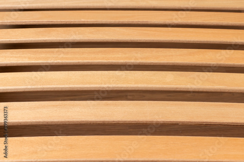 Curved wooden bed slats close-up.
