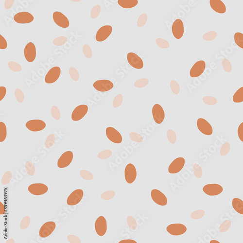 Granola print - healthy food. Geometric seamless pattern with orange and beige ovals on a grey isolated background. Graphic dots, peas, uneven edges. Great for fabric, wallpaper, textile, wrapping.