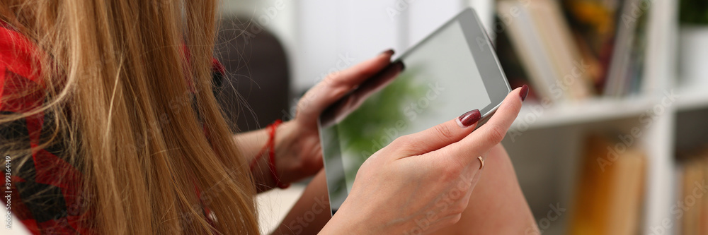 Close up of female hands holding electronic pad PC with black display