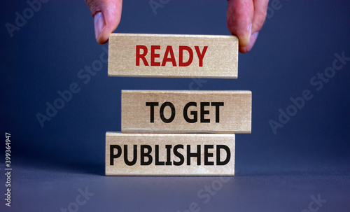 Ready to get published symbol. Wooden blocks with words 'ready to get published'. Male hand. Beautiful grey background. Copy space. Business and ready to get published concept. photo