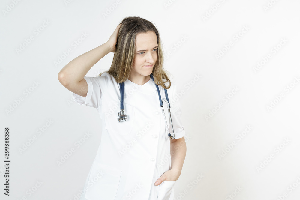 Medicine and health concept. Doctor woman holds her head with her hand. Isolated on white background. Medicine and health concept. Doctor woman holds her head with her hand. Isolated on white background.