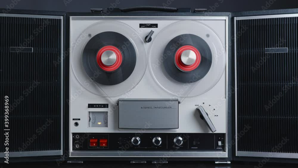 Reel to reel tape recorder playing rewind. Rotating vintage music player  close up. Retro tape. Spinning reels metallic color. Party. Loop. Front  view. Front view. Popular Disco Trends 60s, 70s, 80s Stock