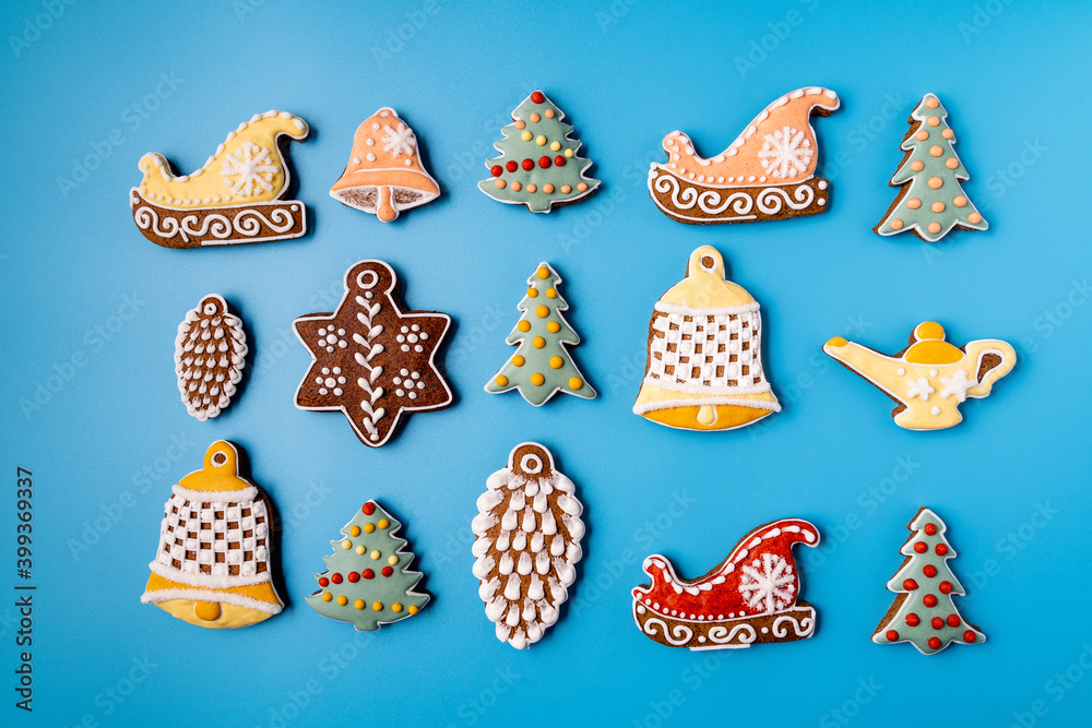 Christmas Gingerbread on a blue background. Snowflake, spruce, star, sleigh, cones, cone, star, bell shape.