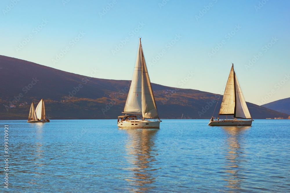 Fototapeta premium Winter Mediterranean landscape with sailing boats on water. Montenegro, Adriatic Sea. View of Bay of Kotor near Tivat city