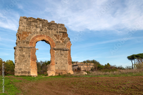 The Parco degli Acquedotti, in the Appio Claudio district, Tuscolano area, Cinecitt, Rome. Is part of the Appia Antica Park. Detail of the arch of the bricks ian a autumn day with blue sky photo
