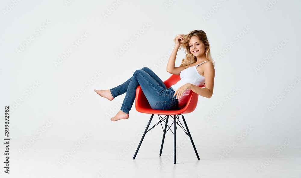 sexy woman sitting on red chair indoors in full growth model sexy woman sitting on red chair indoors in full growth model