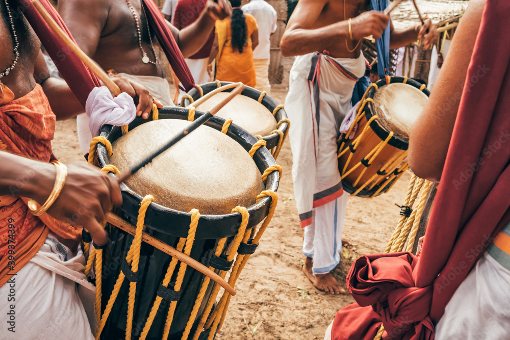 Indian men play traditional percussion drum Chenda in Kerala, India