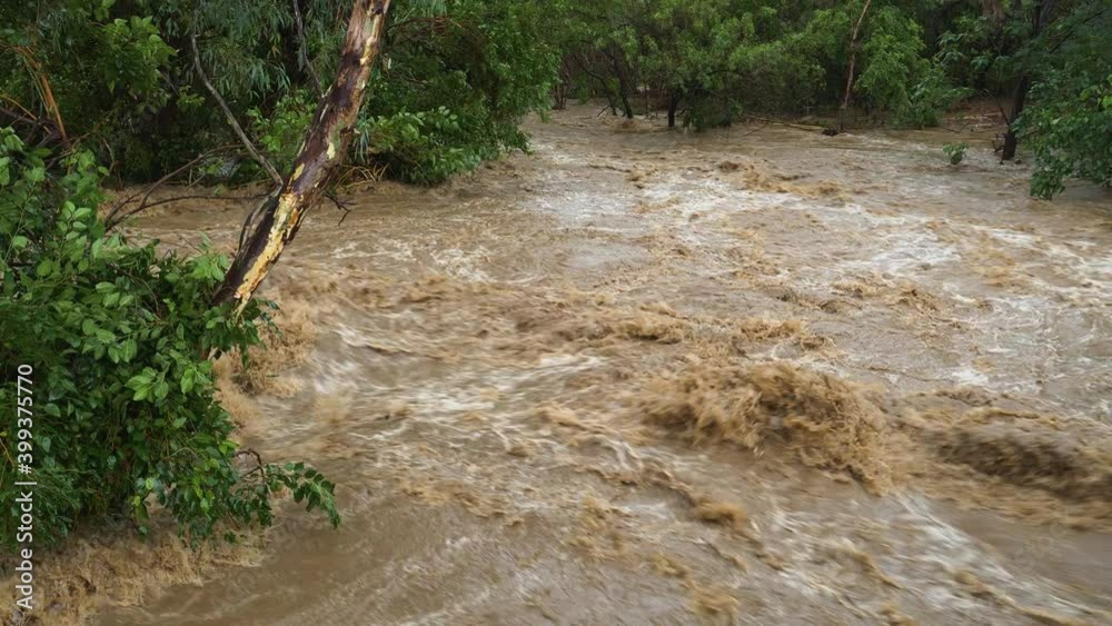 Aerial panning view of a river coming down in flood due to heavy rains from climate change Aerial panning view of a river coming down in flood due to heavy rains from climate change