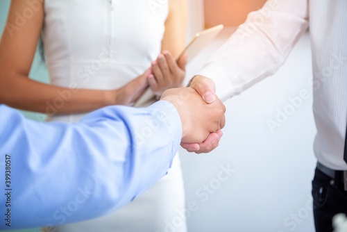 The image of two business people shaking hands after a successful business negotiation
