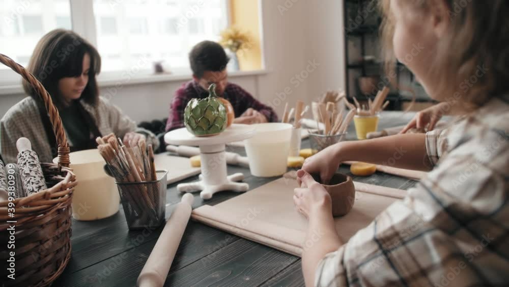 Potter masterclass, Man and woman are working with pottery wheel making pots during master class for adults, creative craftsman hobby. DIY Leisure activities and craftsmanship concept.