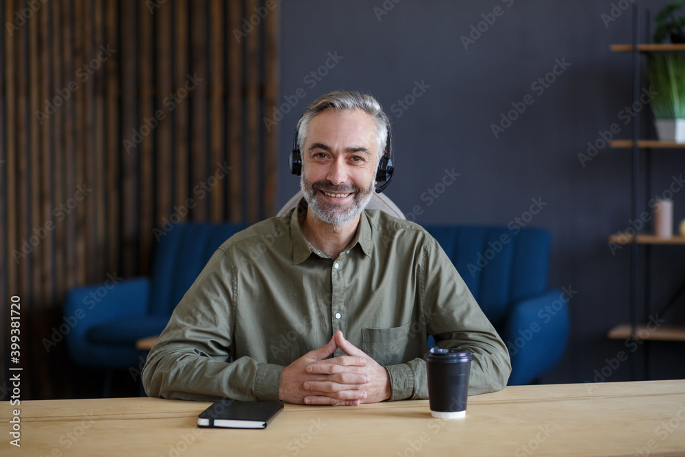 Portrait of grey-haired senior handsome man teaching online. Online education, remote working, home education. Online meeting, video call, video conference, courses online. Portrait of grey-haired senior handsome man teaching online. Online education, remote working, home education. Online meeting, video call, video conference, courses online.