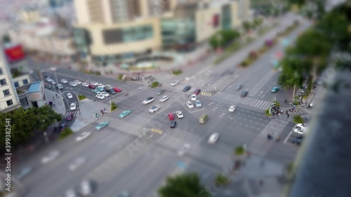 Busy intersection high angle view in China with double left turn lanes. Modern Asian city in Sichuan, commercial center road crossing with stoplights and crowds.