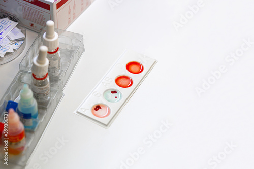 The process of determining the blood group and Rh factor in the laboratory. copy space, text photo