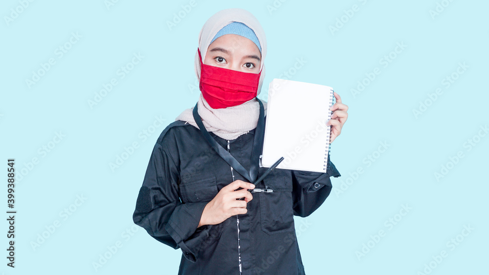 attractive asian hijab woman in red mask holding blank paper. empty copy space for some slogan, text. Business ad concept.