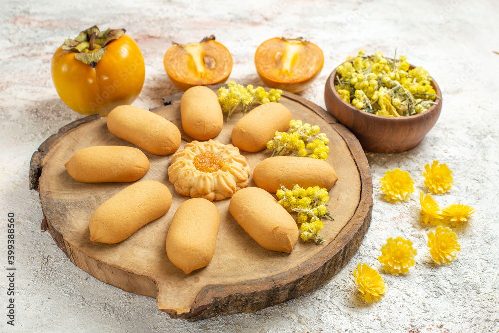 cookies on wooden plater and yellow flowers and palms on marble background cookies on wooden plater and yellow flowers and palms on marble background