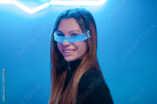 Canvas-taulu Young woman smiling in futuristic glasses. New noir