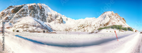 Fabulous winter view of frozen Hamnoyvatnet lake and enterance to tunnel seen from  Akkarvikodden Reststop. photo