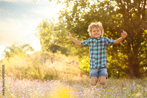 Cute little boy having fun outdoors  space for text. Child spending time in nature