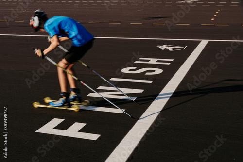 Teen roller skier crossing finish line