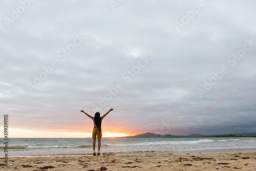Girl enjoying sunset on the beach