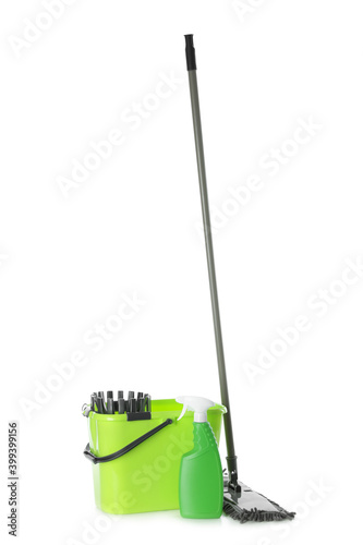 Mop, detergent and plastic bucket on white background. Cleaning supplies