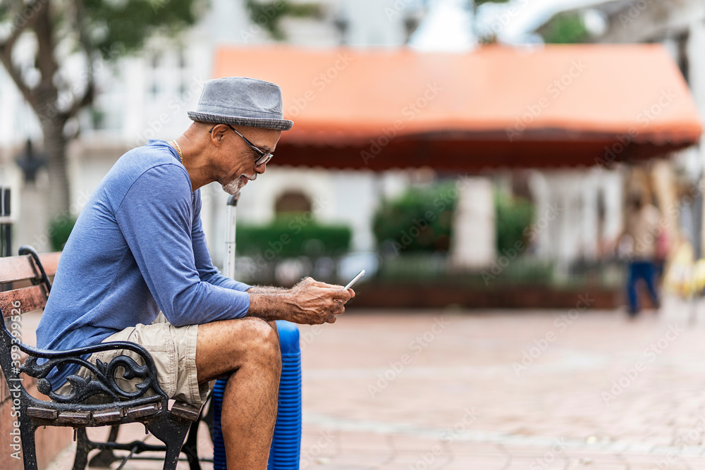 Senior black man sitting on a bench. Senior black man sitting on a bench.