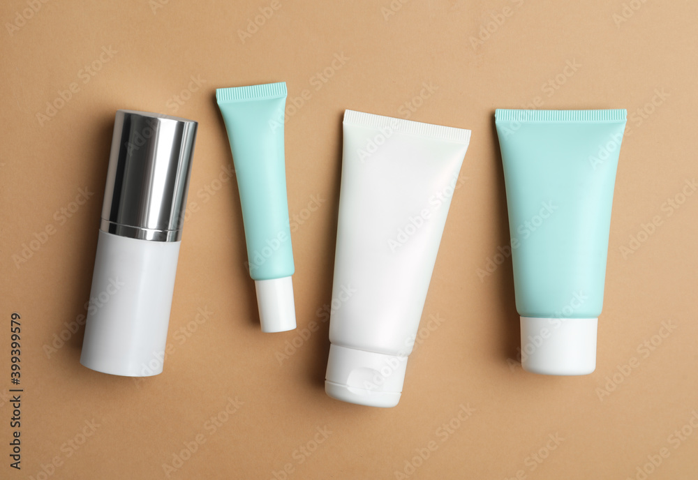 Set of luxury cosmetic products on light brown background, flat lay Set of luxury cosmetic products on light brown background, flat lay