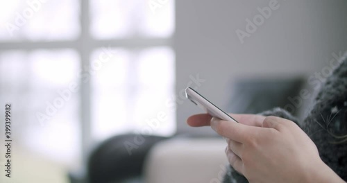 Wallpaper Mural Woman Texting Typing Scrolling on Mobile Phone Smartphone in Bright Living Room Torontodigital.ca