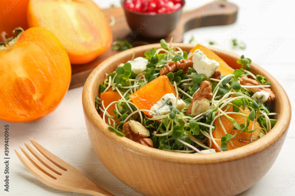 Delicious persimmon salad served on white table, closeup Delicious persimmon salad served on white table, closeup