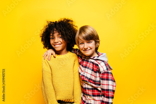 Two children looking at the camera in studio.