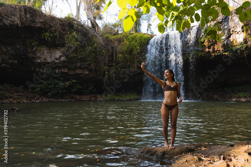 African girl enjoying a waterfall photo