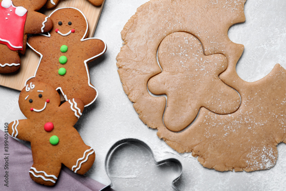 Flat lay composition with homemade gingerbread man cookies on light grey table