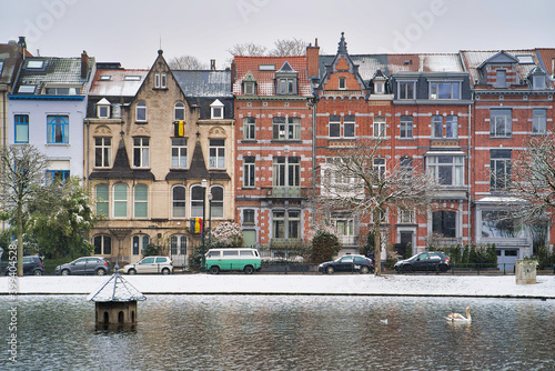 Obraz na płótnie Winter Brussels, snow-covered houses. City landscape with lake in winter, Belgium w salonie