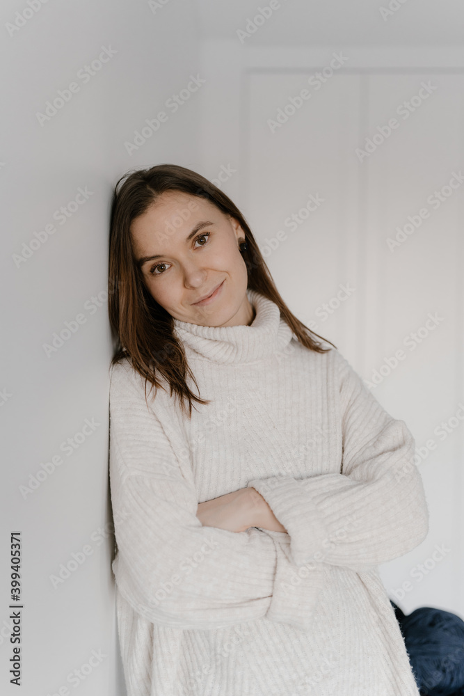 Charming calm woman in sweater looking at camera Charming calm woman in sweater looking at camera