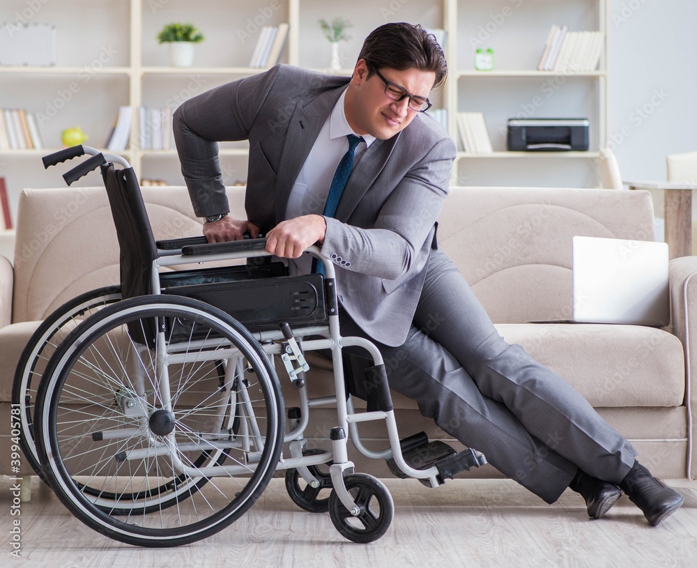Dsabled businessman on wheelchair working home Dsabled businessman on wheelchair working home
