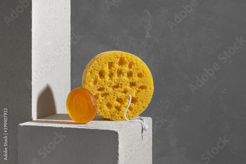 Soap bars and scrubbing Sponge over gray background photo