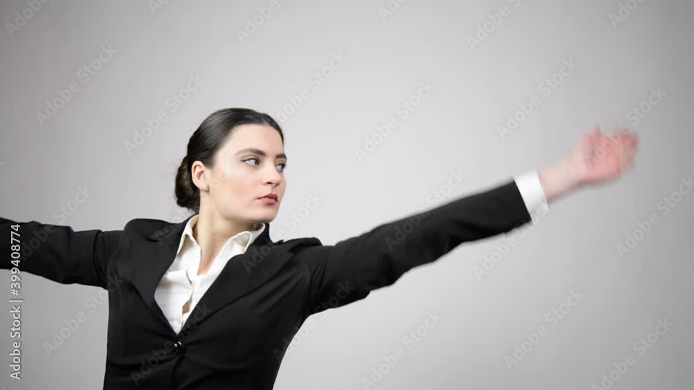 Beautiful business woman wearing a black suit with a white shirt dancing ballet Beautiful business woman wearing a black suit with a white shirt dancing ballet
