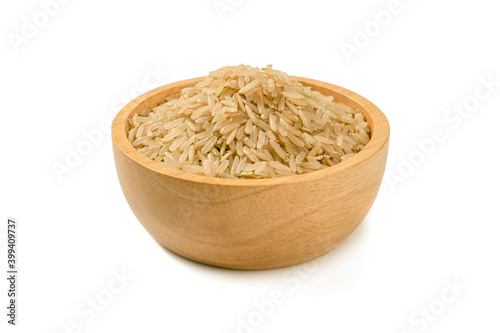 Rice grains in wooden bowl isolated on white background.
