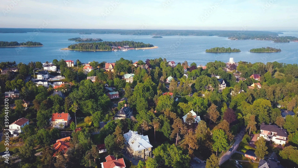 aerial high view of lake and houses between forest trees, Sweden.