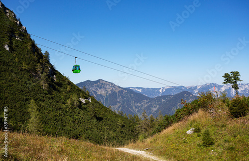 Austria, Upper Austria, Bad Ischl, Overhead cable car moving over forested mountain valley photo