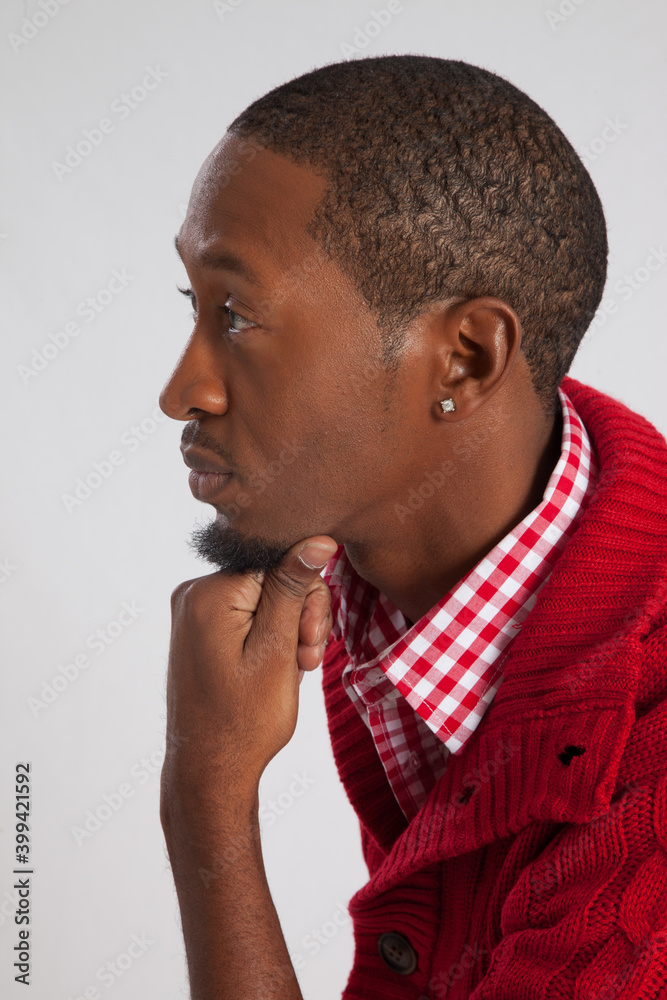 Thoughtful Black man with his chin on his hand Thoughtful Black man with his chin on his hand