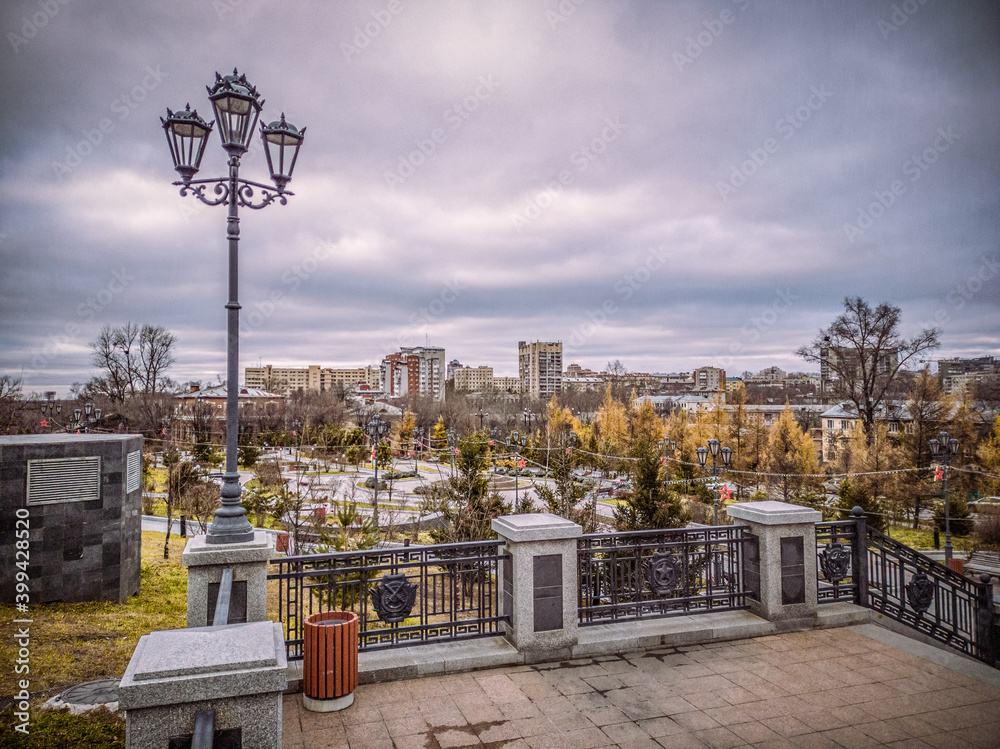 Nice view of the city park in Khabarovsk in autumn. Marble stairs and paving stones.