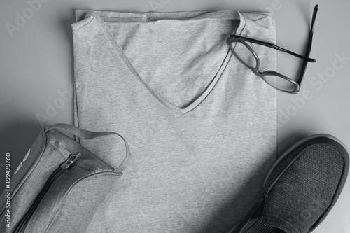 Top view of men's fashion clothing and accessories in a gray background